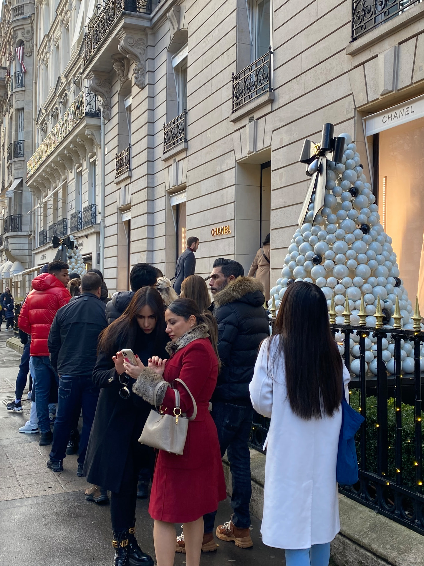 Holiday queue outside a Paris boutique in December